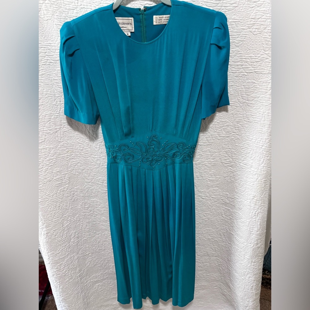 Karin Steven’s 90’s teal dress with beaded and soutache waistline trim